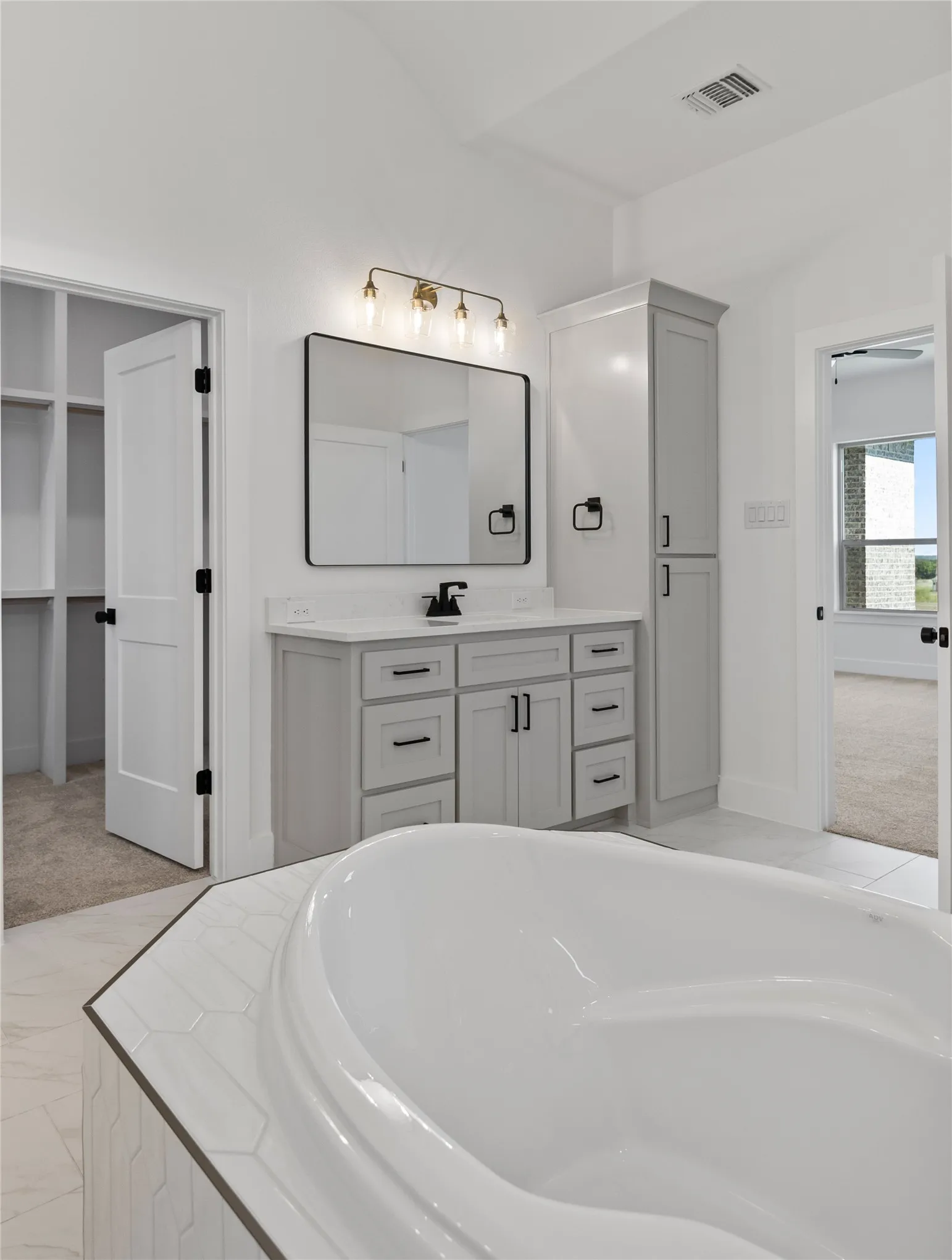 Freestanding bathtub with hexagon tile surround
