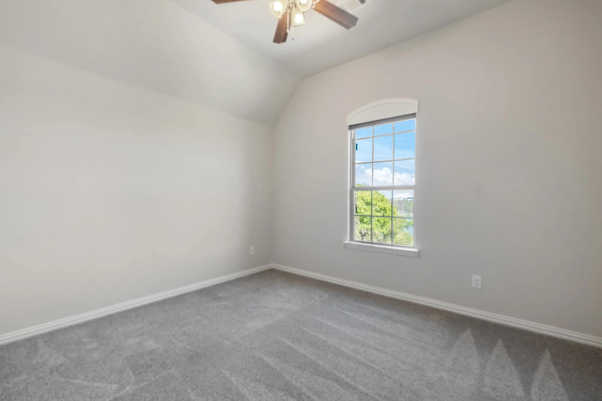 Upstairs fourth bedroom, vaulted ceiling with ceiling fan.