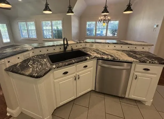 central kitchen sink and counters that opens to a living area