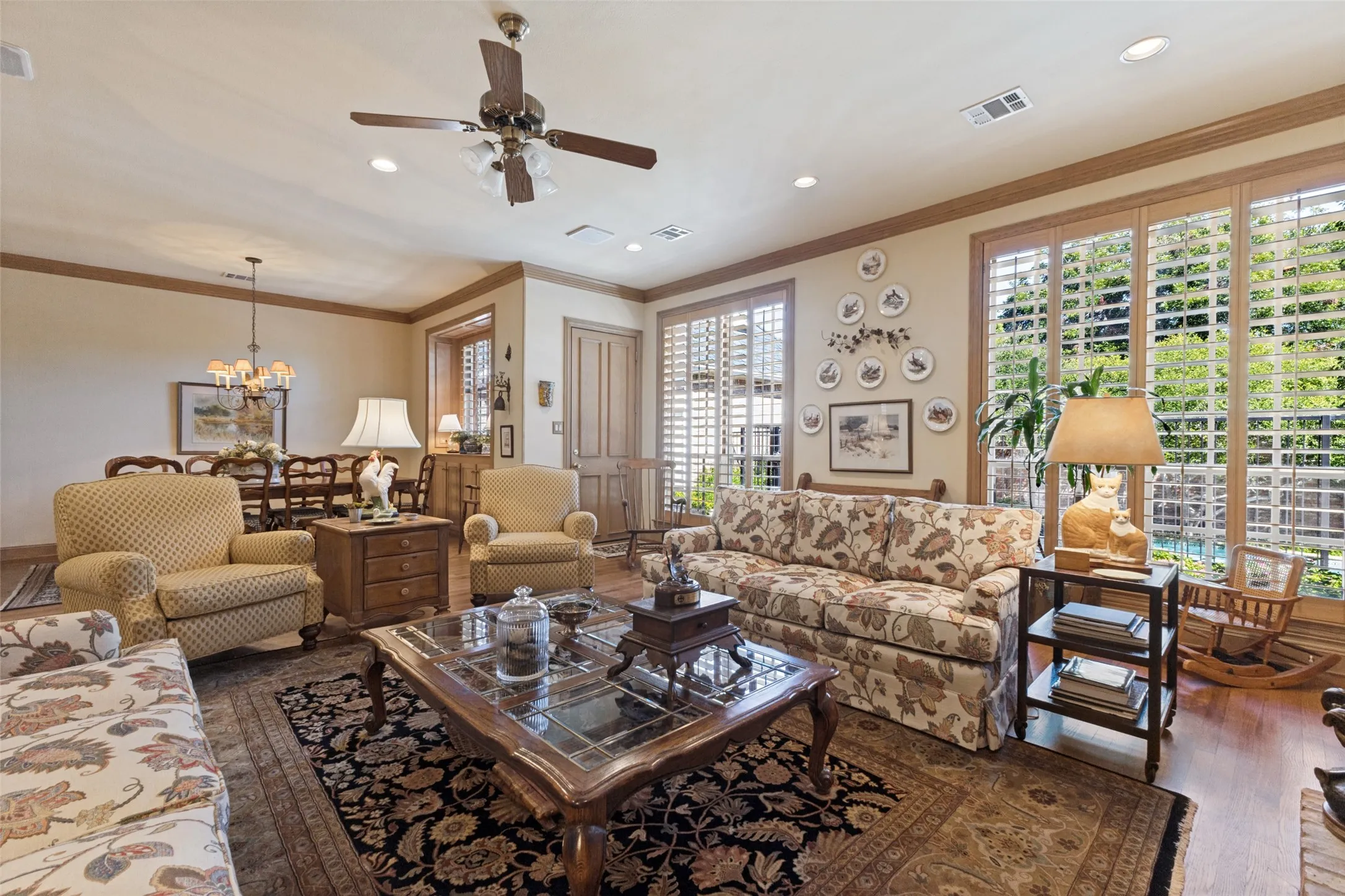 Recessed lighting and ceiling fan, wood-finish flooring, plantation shutters, and crown molding