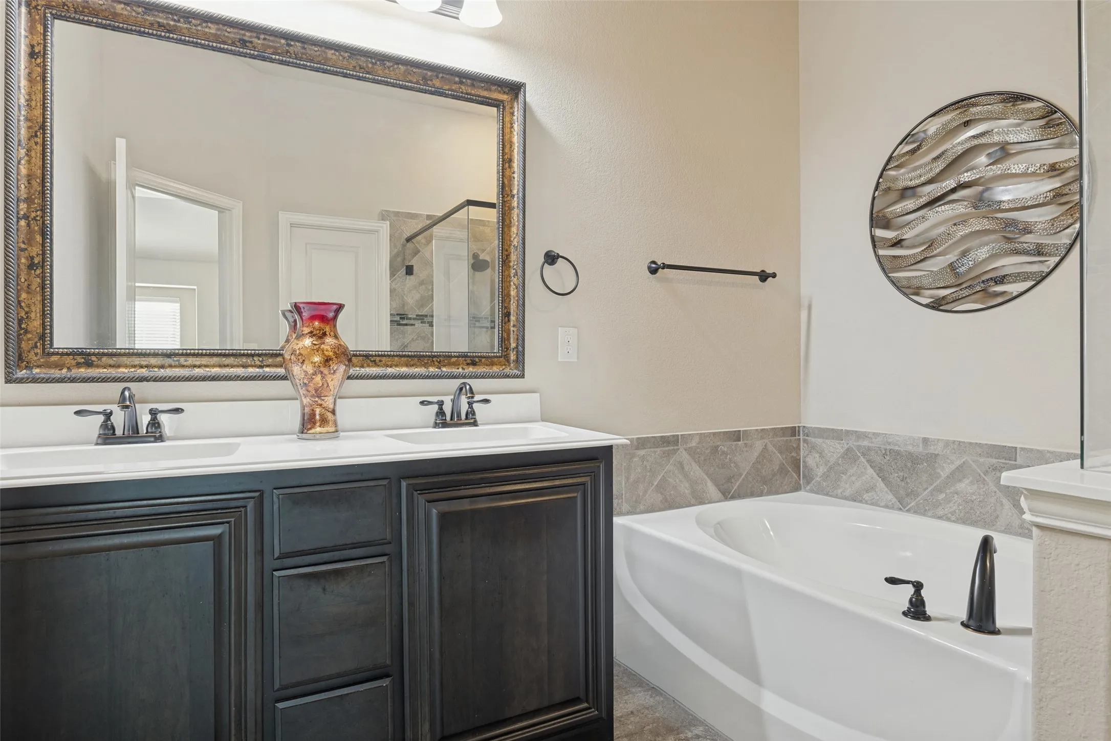 Primary bath with dual sinks, garden tub, and separate shower.