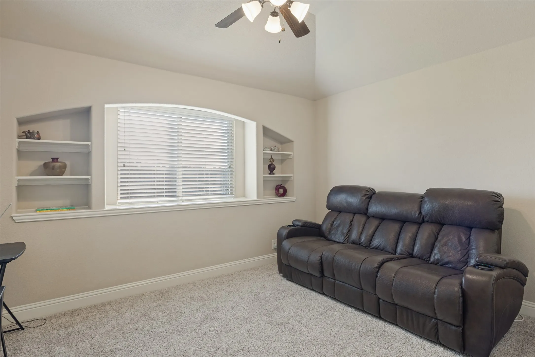Secondary bedroom which has shelves and large window,