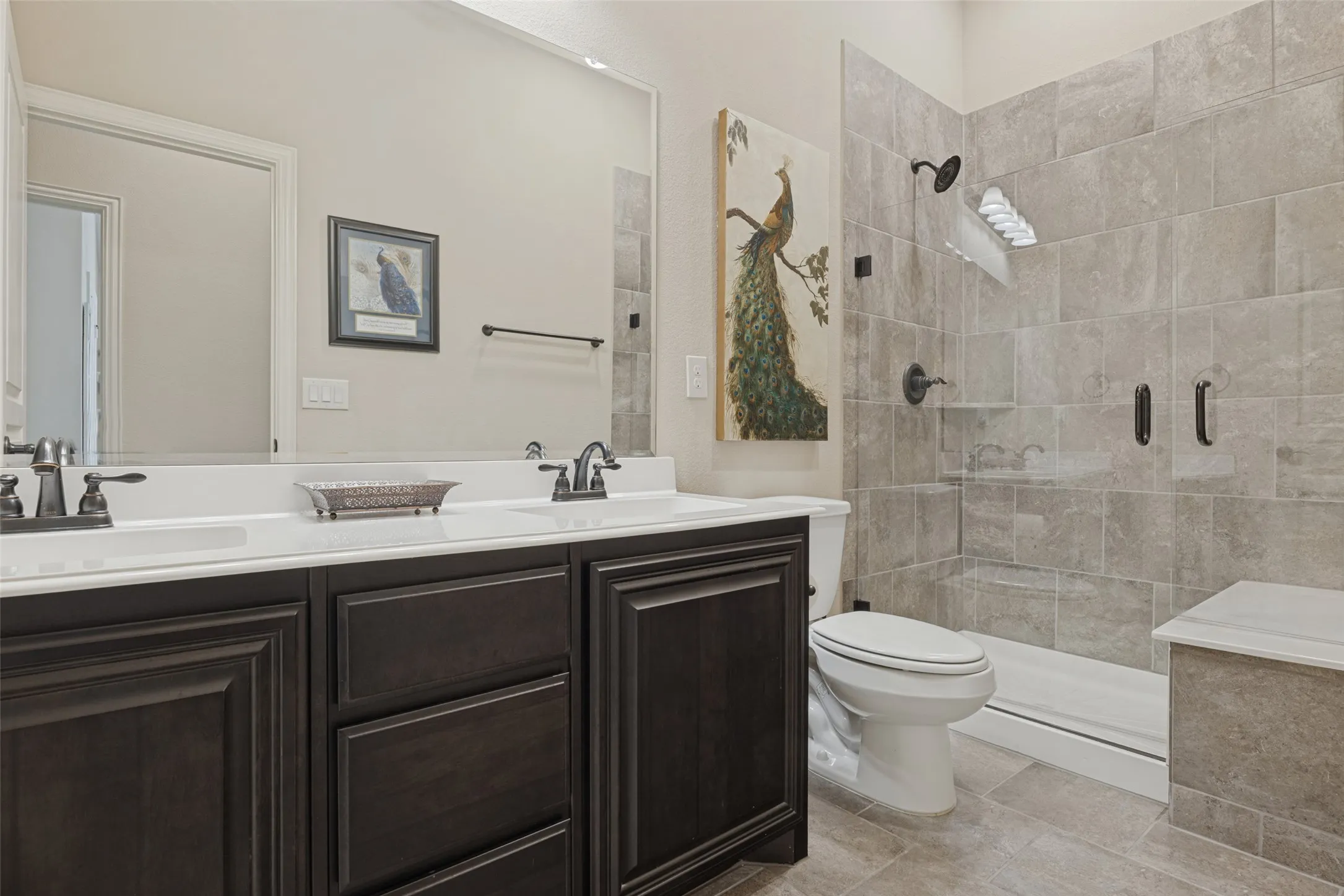 Hall bath with dual sings and walk in shower with seat.