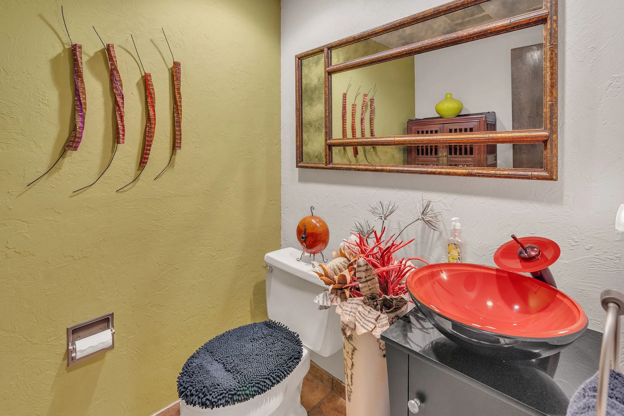 Glamorous half bath in hallway with artistic sink and faucet