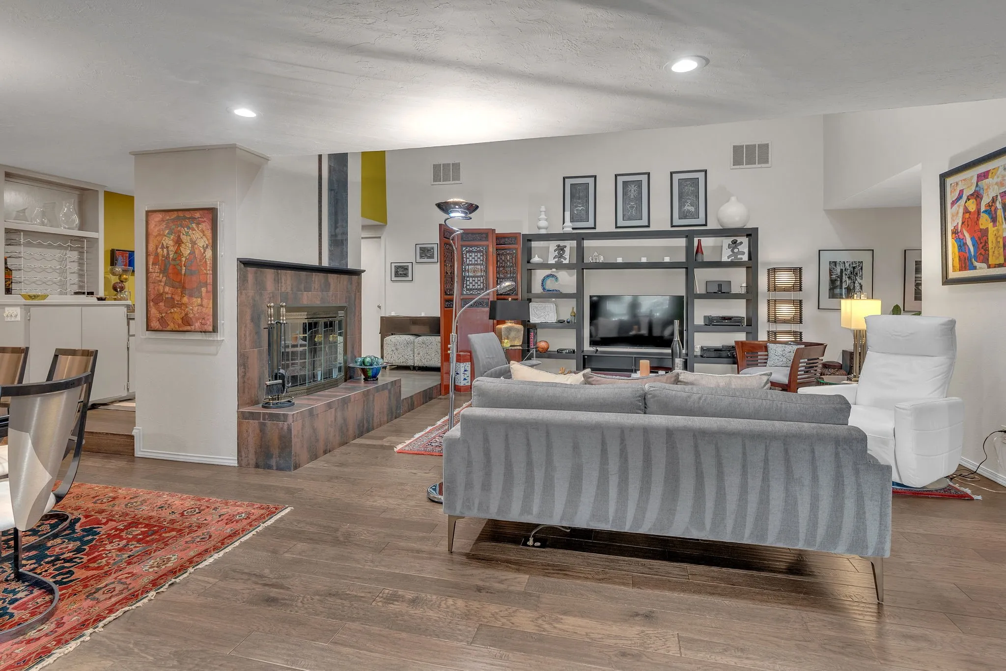 Living area with recessed lighting, wood burning fireplace, and wet bar