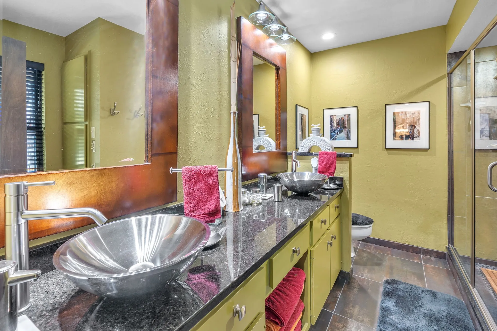 Upstairs bathroom with double stainless steel sinks and clear glass walk in shower