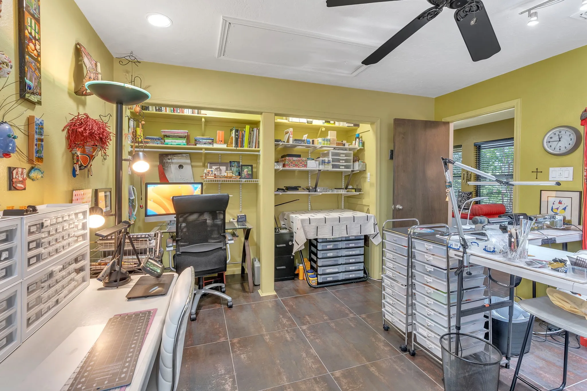 Upstairs bedroom used as an art studio. Ceramic tile floor and recessed lighting.