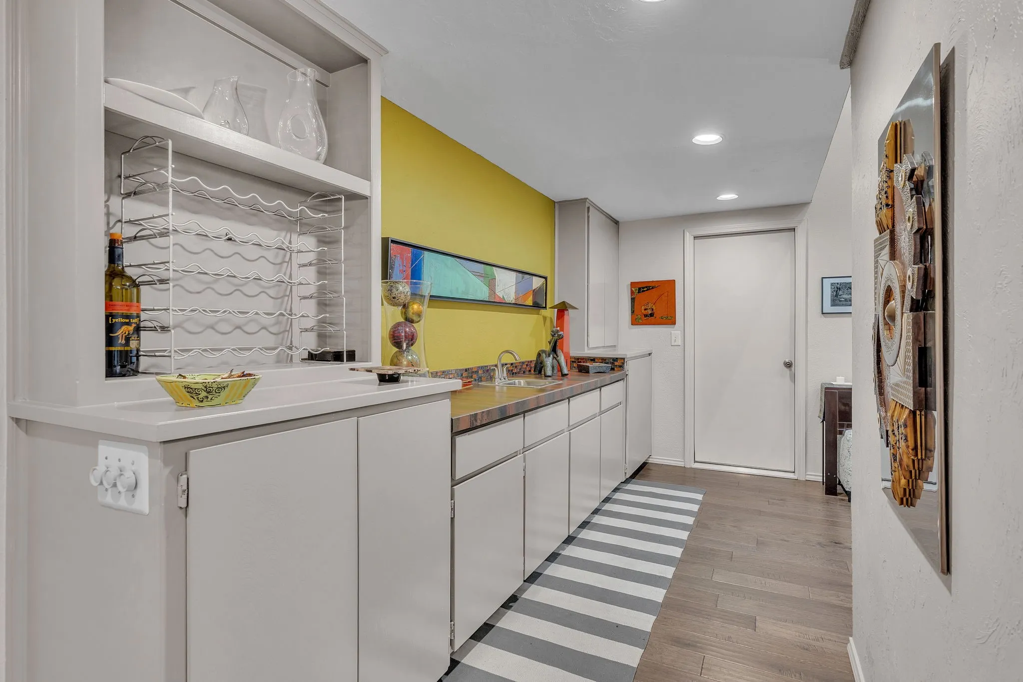 Wet Bar with an abundance of storage. Doorway to 2 car garage.