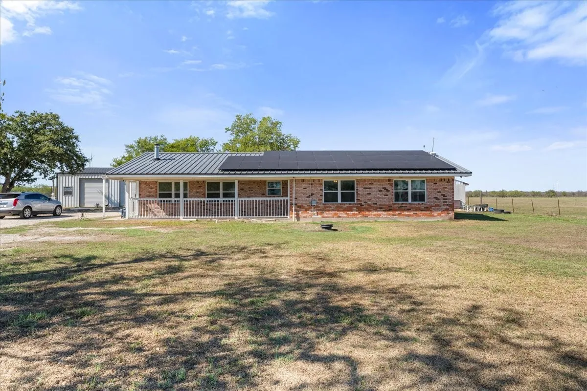 Brick exterior with a covered front porch featuring white railings