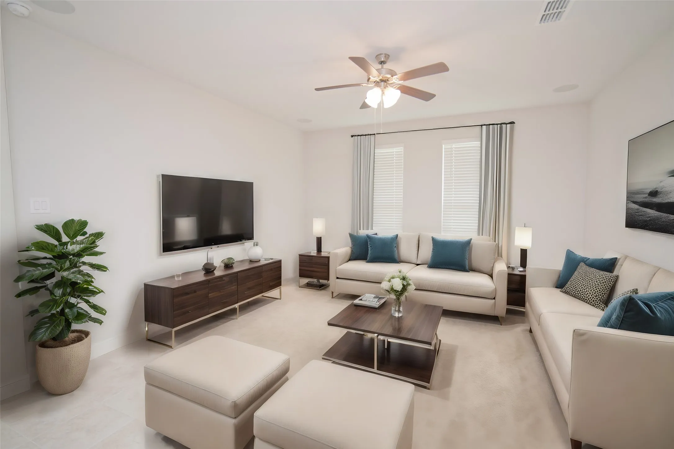 Recessed lighting, ceiling fan with integrated lighting, wood-finish media console, two windows with blinds, and light-toned carpet