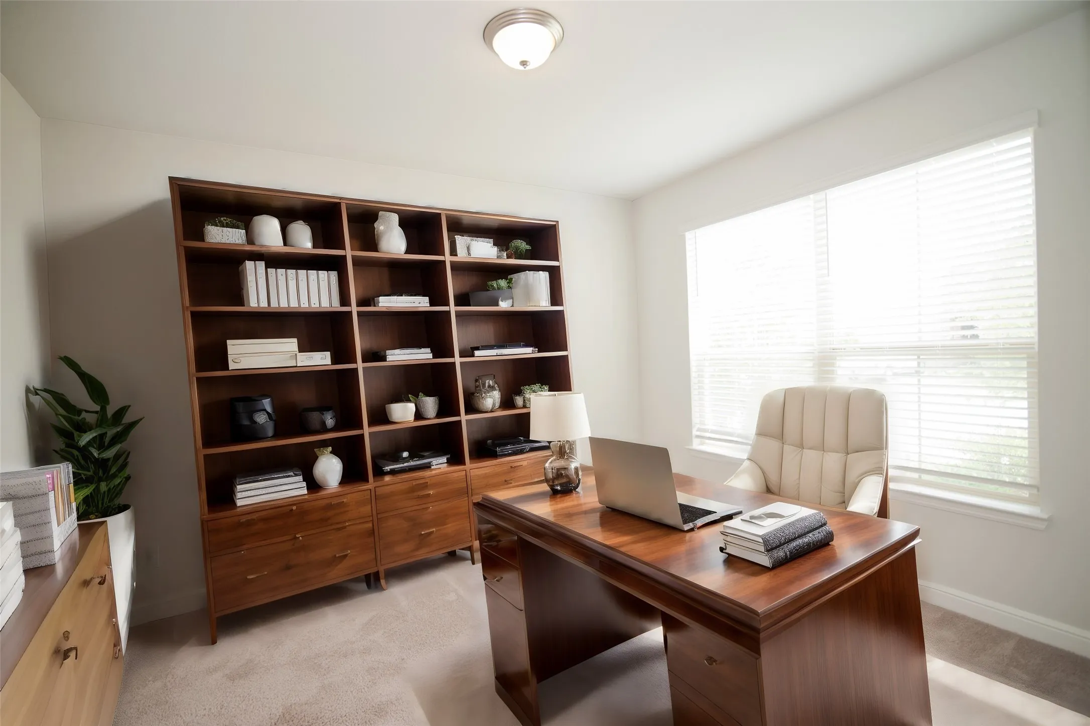 Built-in shelving unit, broad window with blinds, recessed lighting fixture, and carpeted flooring