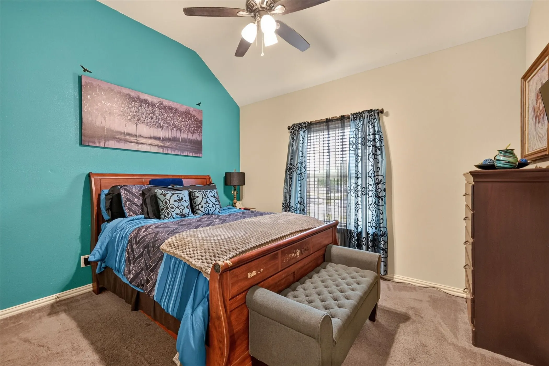 Vaulted ceiling with a ceiling fan, carpet flooring, window with blinds, and a built-in dresser