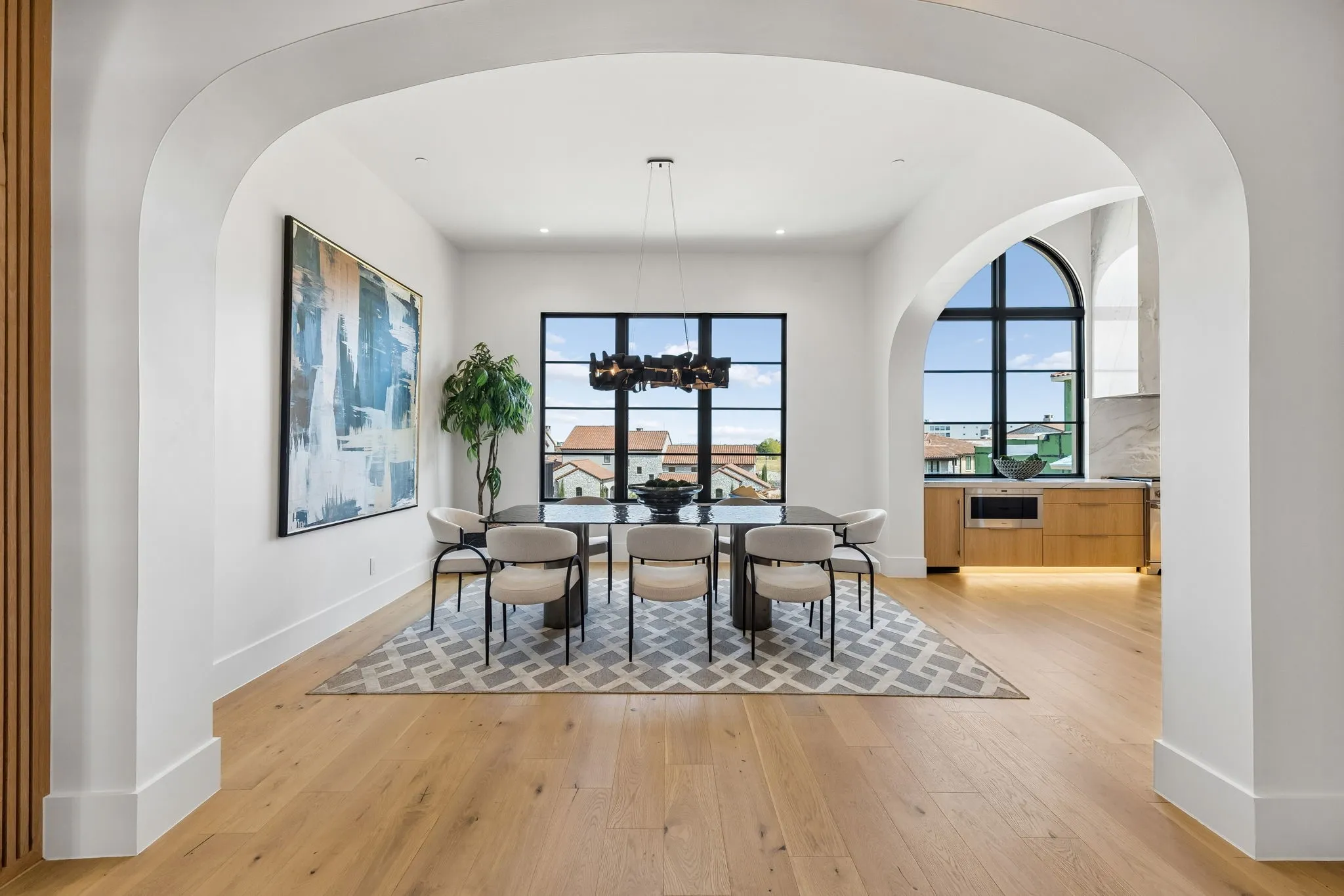 Dining space featuring plenty of natural light, white oak wood floors, a designer lighting, and recessed lighting