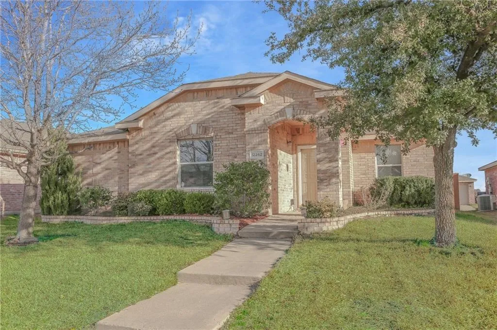 View of front of home featuring a front lawn and brick siding