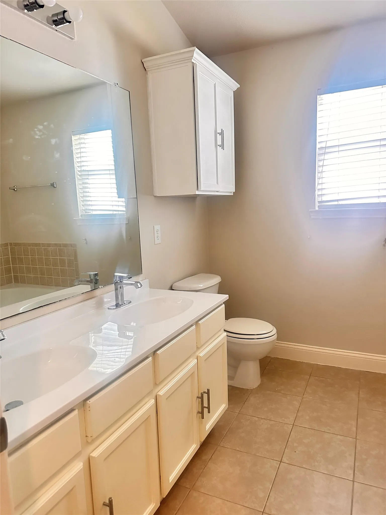 Full bathroom with light tile patterned floors and a garden tub