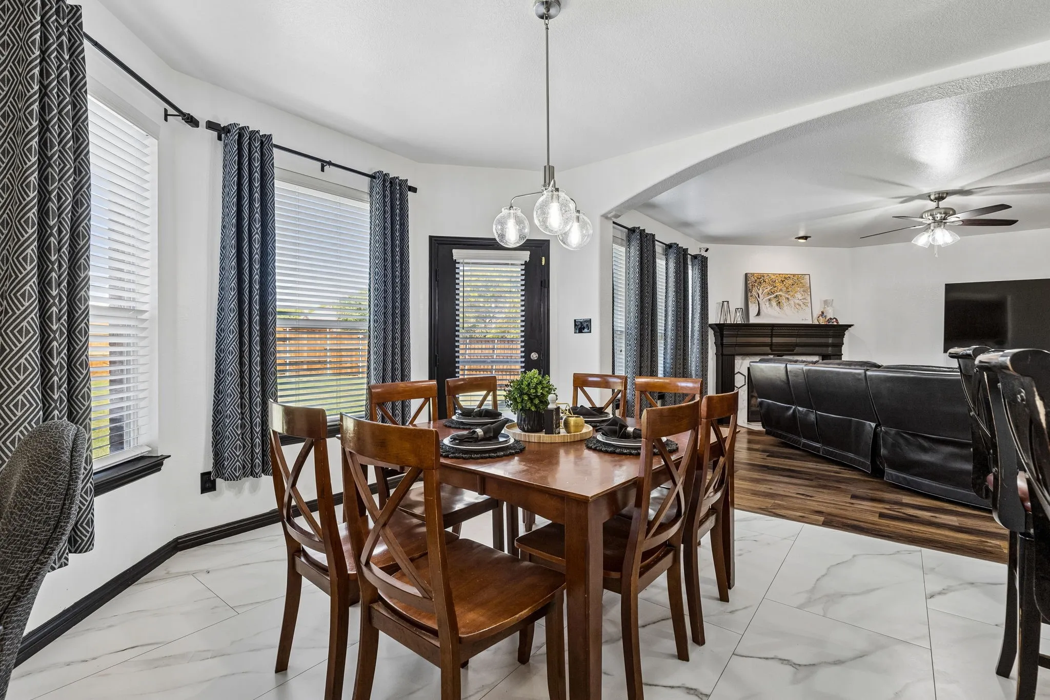 Enjoy the Backyard Views – A charming curved wall of windows brings natural light into the breakfast area, while a glass-paneled exterior door provides direct backyard access. The open archway connects this inviting space to the family room.