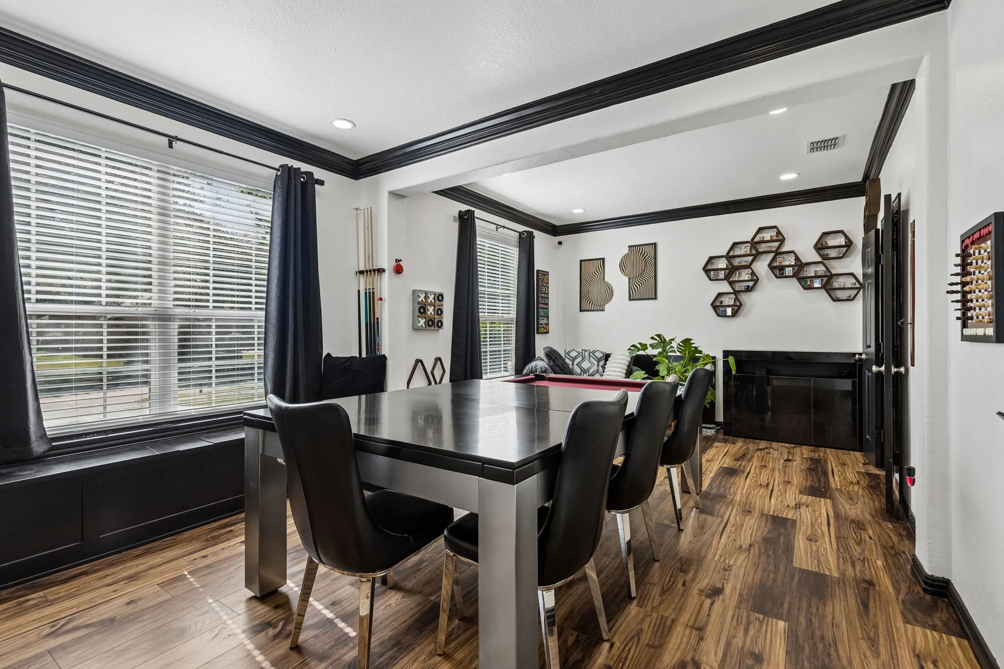 Flexible Living Spaces for Your Lifestyle – Originally designed as formal living and dining rooms, these connected spaces currently serve as a spacious game room. Waterproof laminate flooring, large front-facing windows, and a built-in window seat with storage add versatility and function.