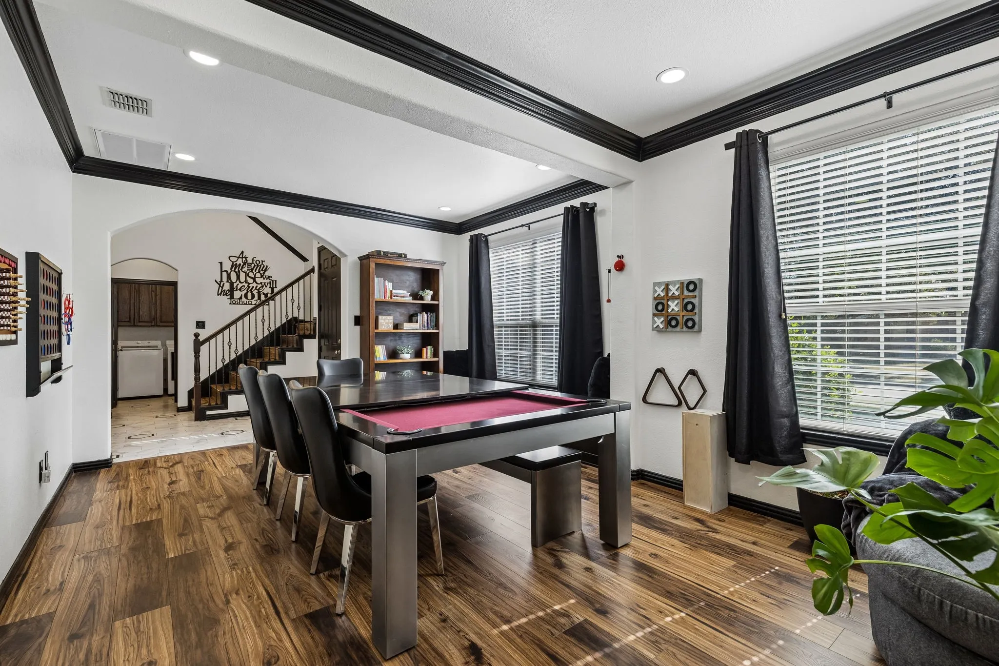 Designed with Flexibility in Mind – A wide opening connects the two front living spaces, creating an adaptable floor plan with easy access to the entry and staircase. Fresh paint, updated flooring, and contrasting black trim give the rooms a distinctive look.