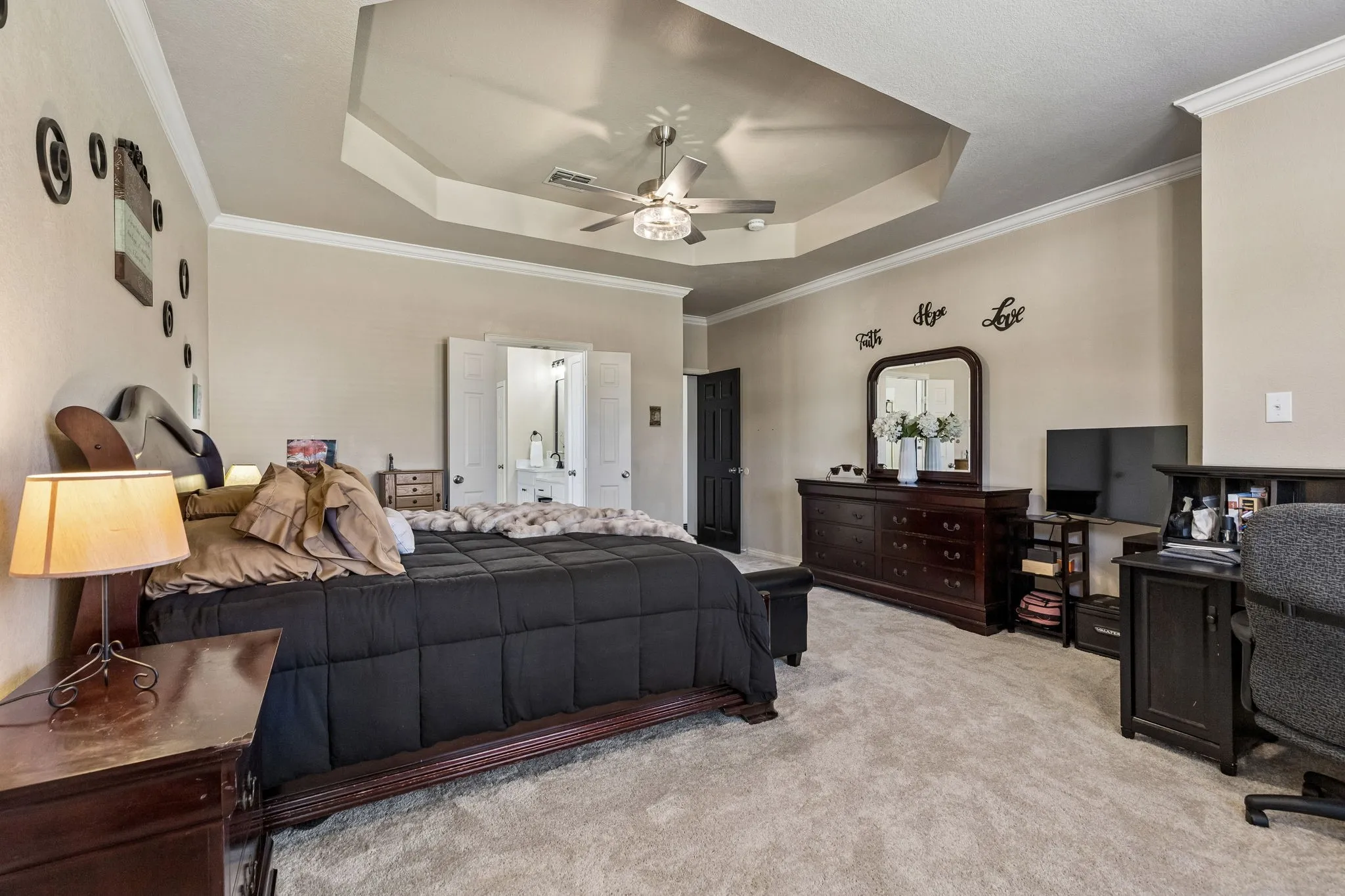 Room to Relax, Work, and Recharge – The oversized primary suite offers the flexibility of two rooms in one, with ample space for a bedroom arrangement and a separate sitting or workspace. Crown molding, a dramatic tray ceiling, and direct access to the updated primary bath complete this impressive retreat.
