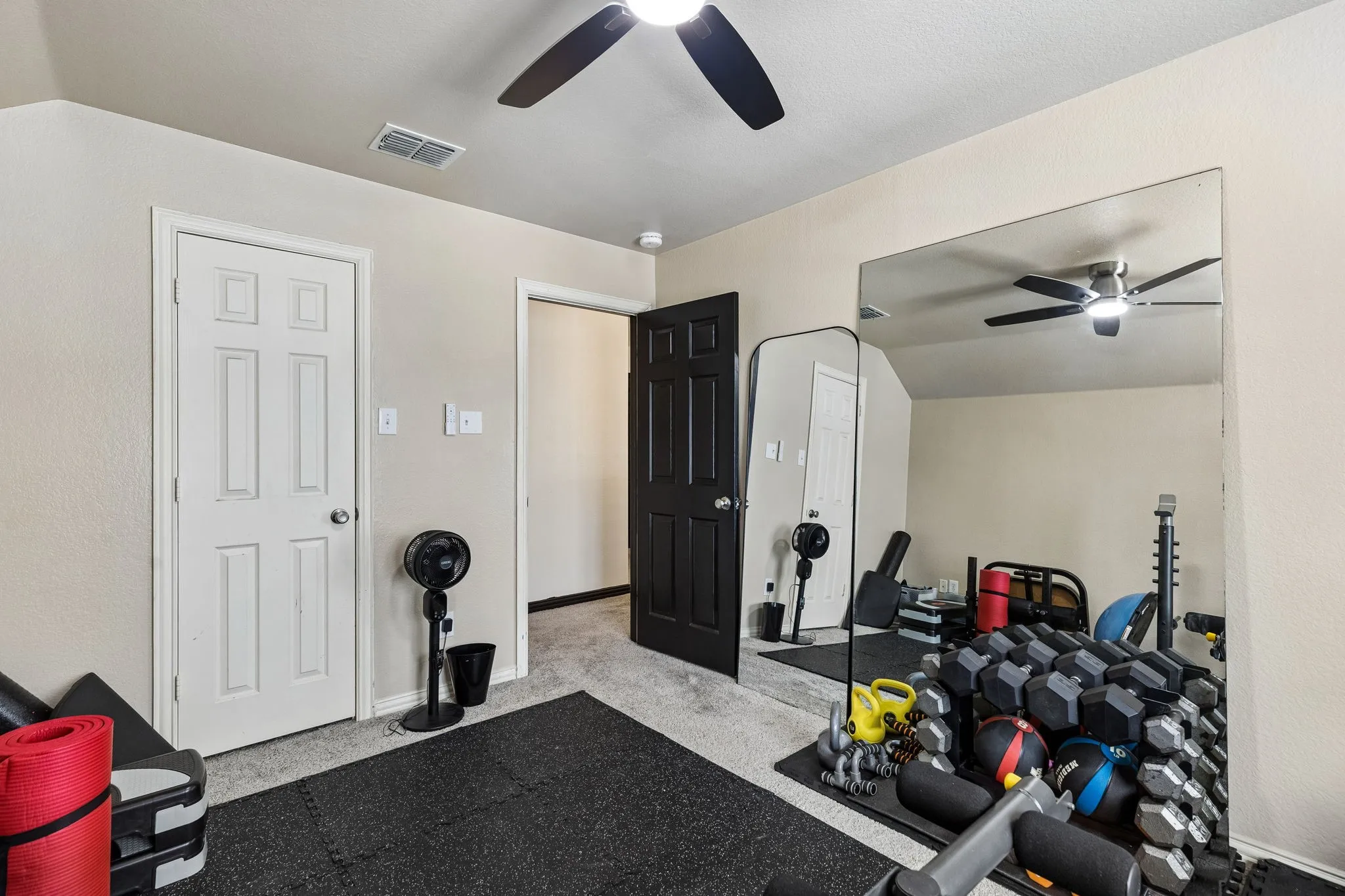 Spacious Bedroom with Room for More – This generously sized upstairs bedroom features soft carpeting, an updated ceiling fan with lighting, and a large window that welcomes natural light. The roomy layout comfortably accommodates sleeping, studying, and additional furnishings.