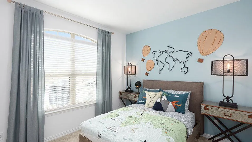 Arch-top window with blinds, light blue accent wall, and neutral carpeting