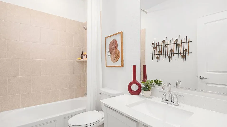 White vanity with an integrated sink, polished chrome faucet, and expansive wall mirror
