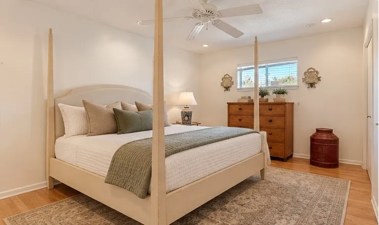 Virtual staged bedding. Light wood-finish flooring, recessed lighting, and a ceiling fan