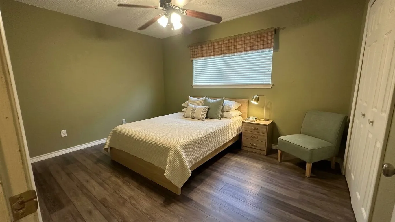 Staged AI furniture;  Middle BR, hard flooring matches the hall wood flooring, CF, double door closet.