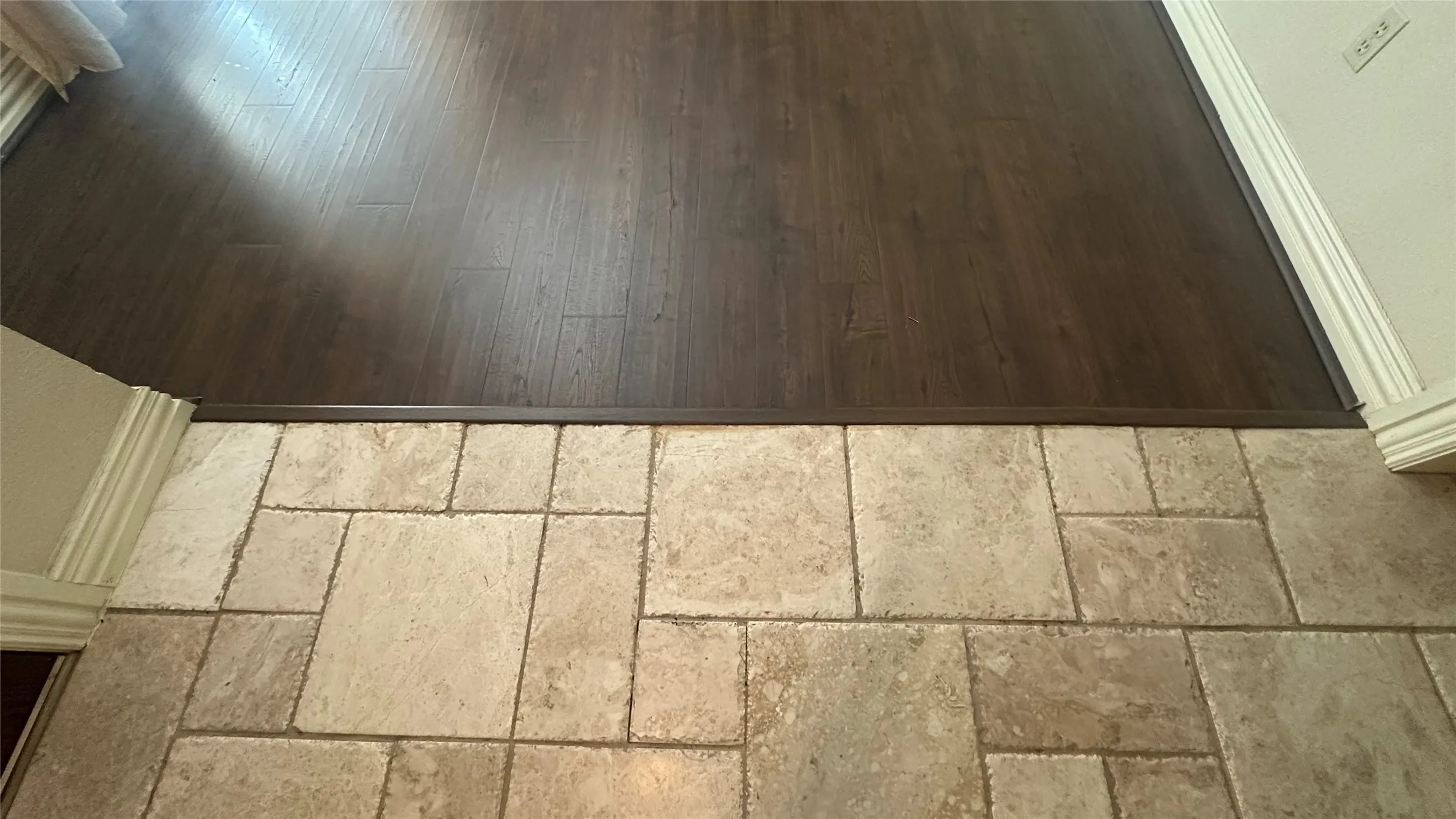 Wood-finish flooring throughout the formal LR-DR, Hallway and middle bedroom.  Entry is pretty tile of multiple size, neutral colors.