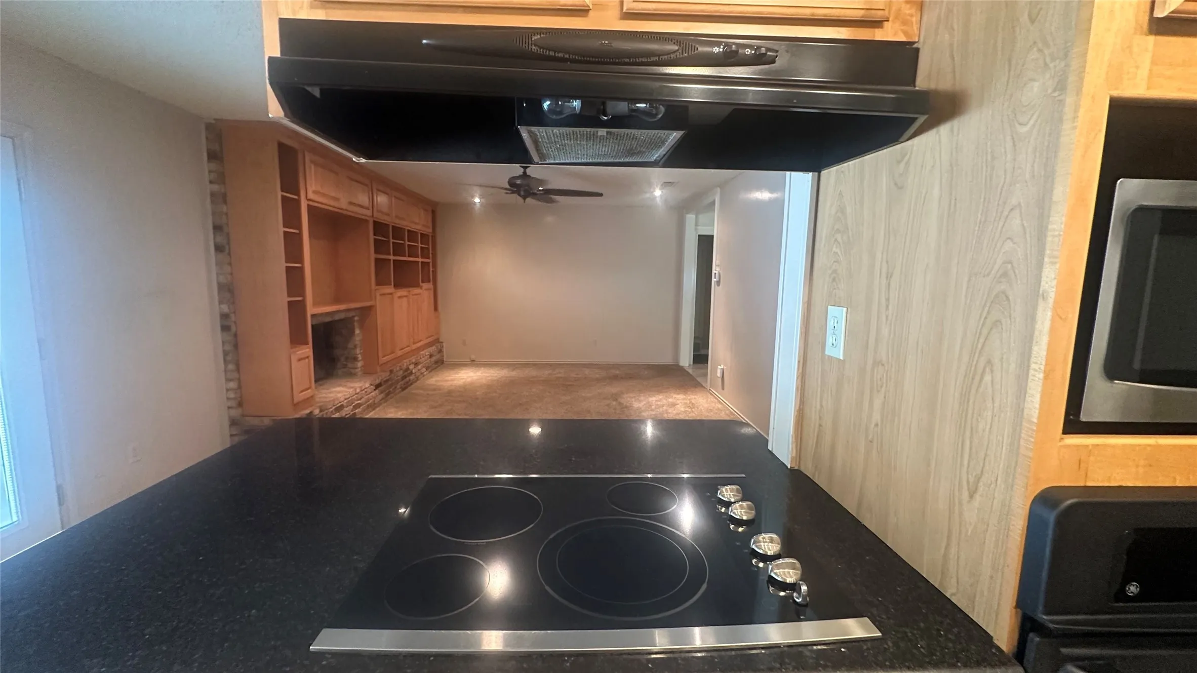 Built-in cooktop with black surface, stainless steel trim, and control knobs