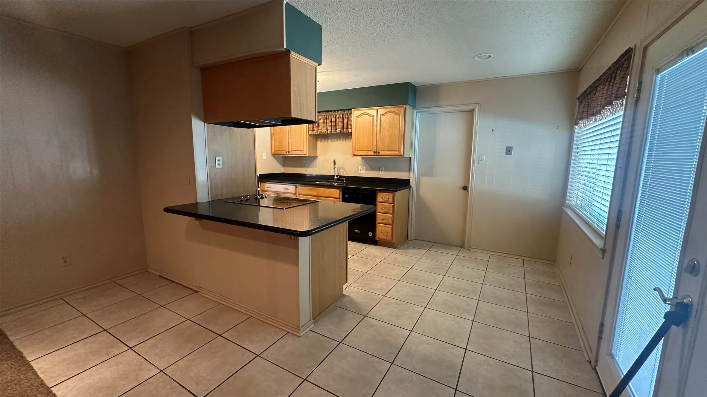 View from Den into breakfast area, breakfast bar and into kitchen.