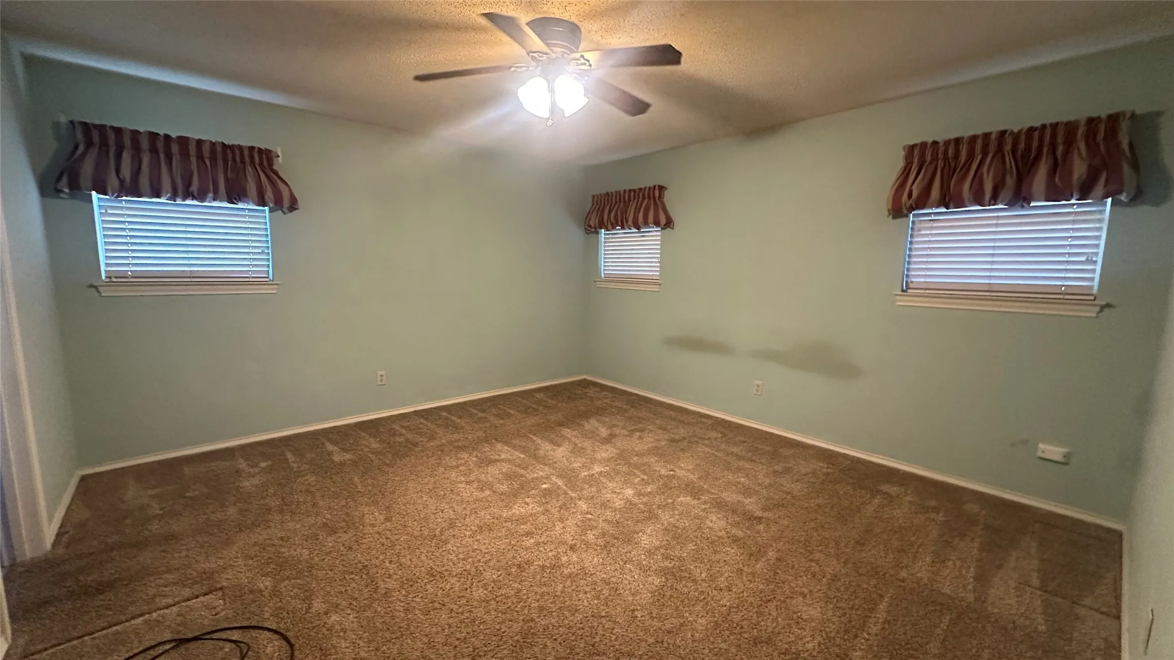 Unfurnished view of primary BR, Carpeted room with a ceiling fan