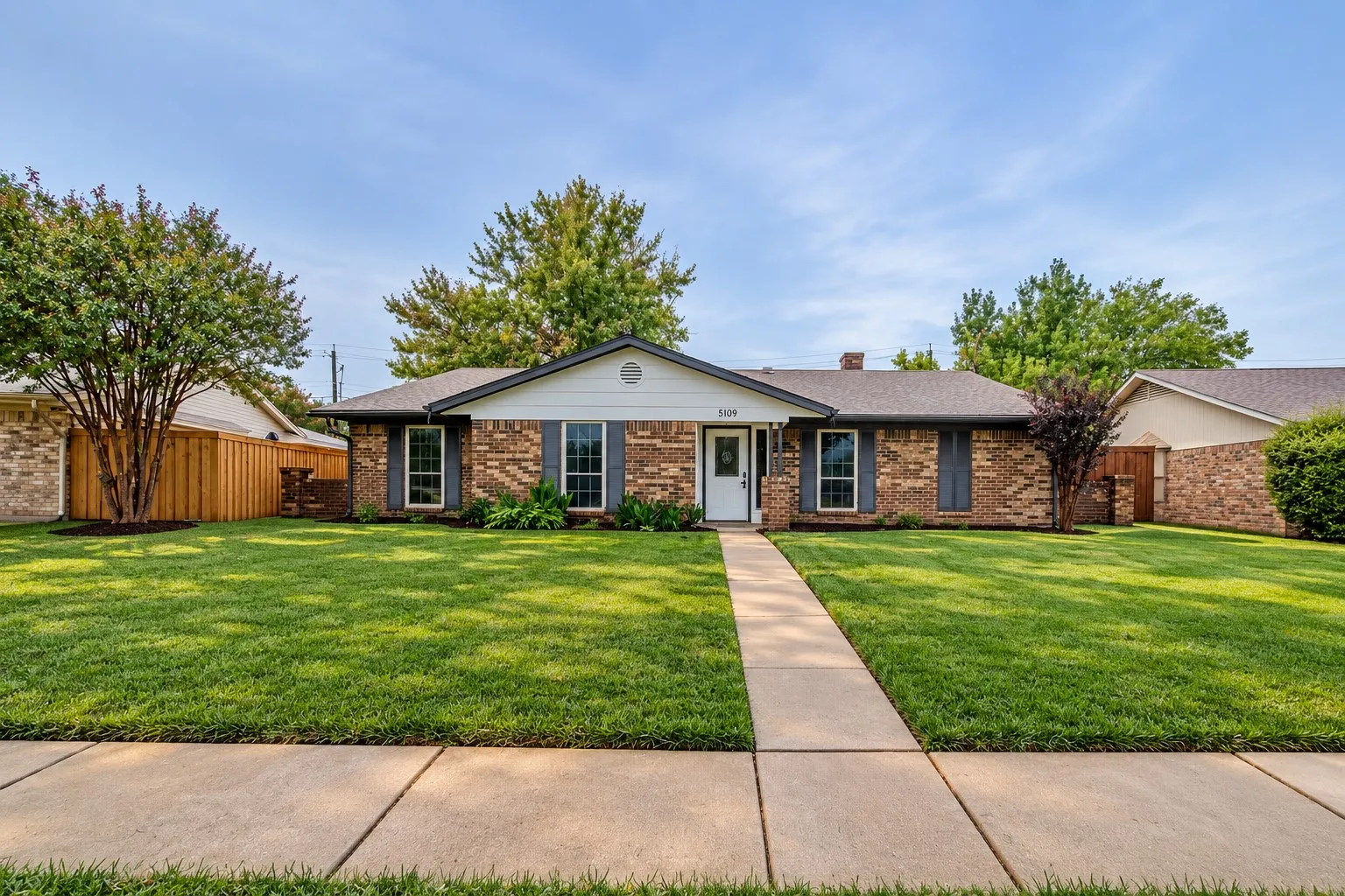 Brick exterior with white trim and dark shutters