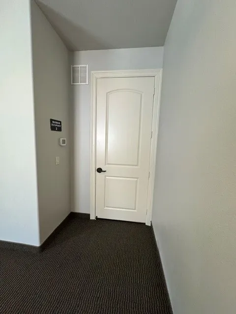 White paneled door with black hardware