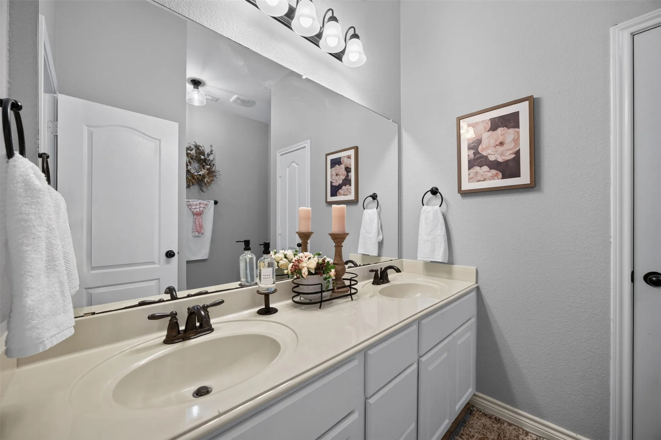 Bathroom with dual sinks and bathtub