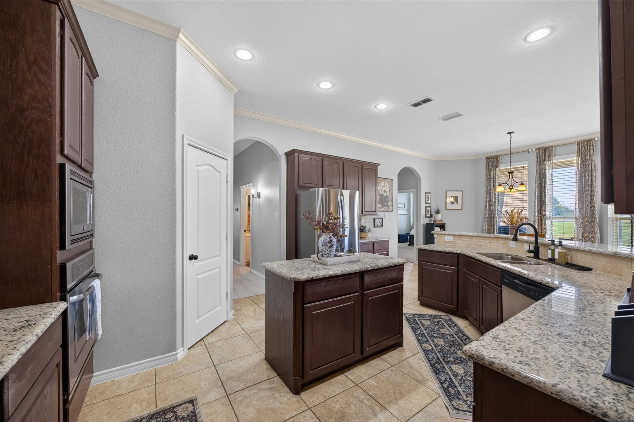 Granite kitchen with island and walk-in pantry