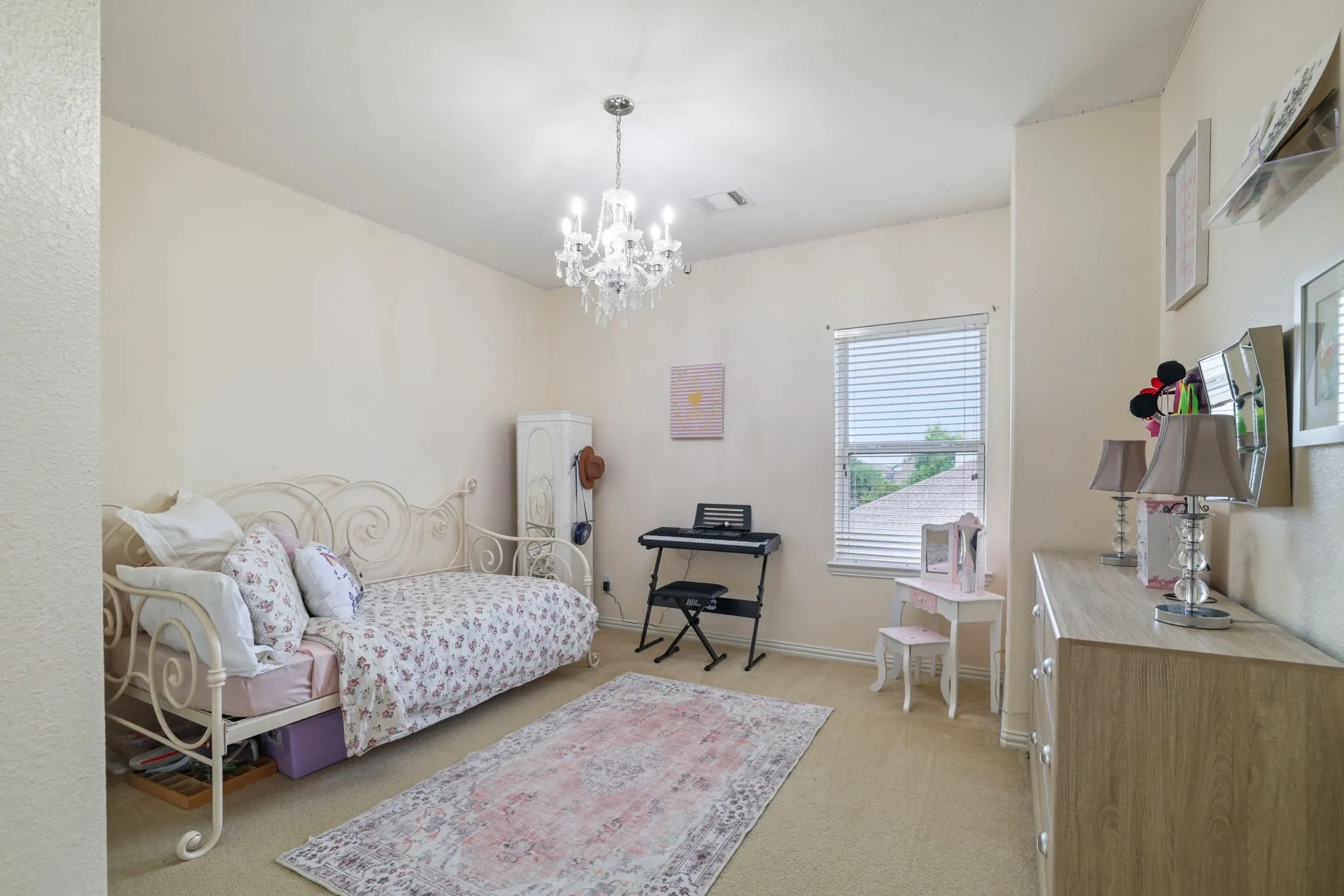 Recessed lighting, chandelier, window with blinds, and neutral-toned carpeting