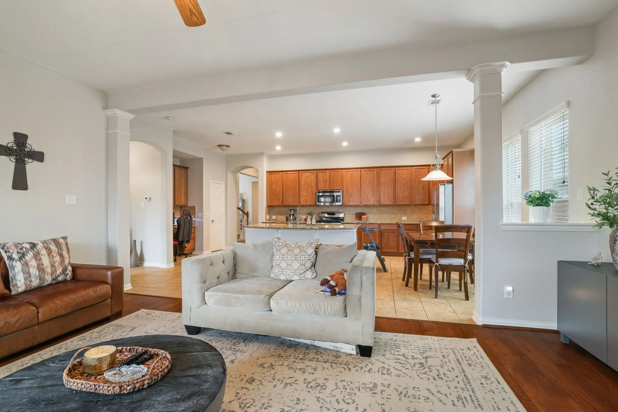 Spacious interior with wood-finish flooring, recessed lighting, and decorative columns