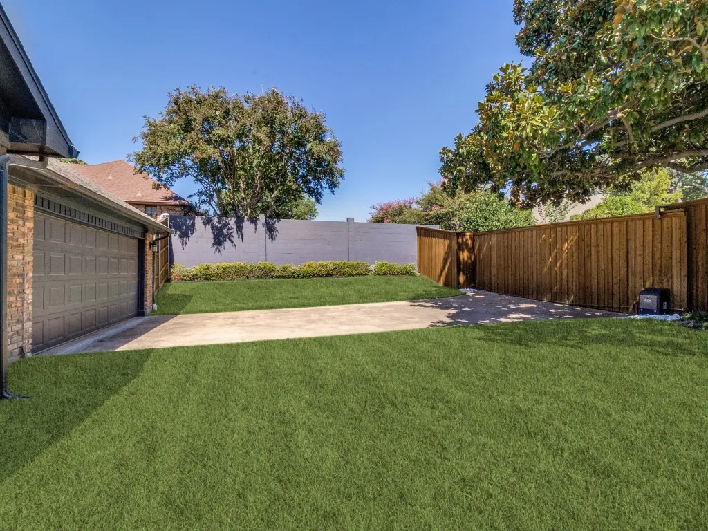 Huge grassy yard with spacious driveway and electric gate