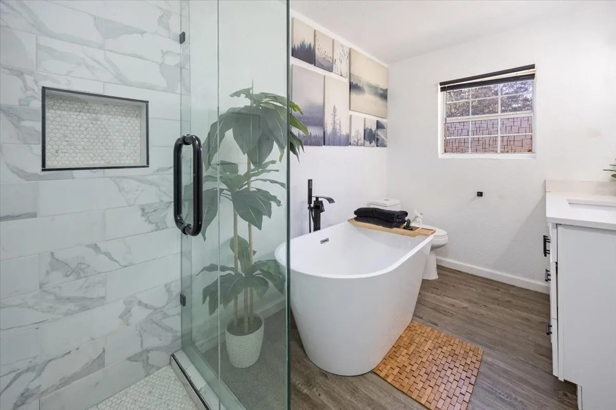 Hall full bath with separate glass shower and fabulous tub!