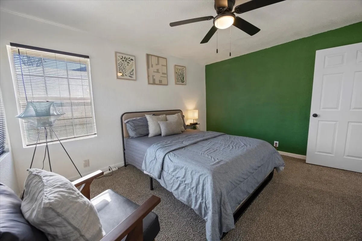 Another view of third bedroom with corner window.