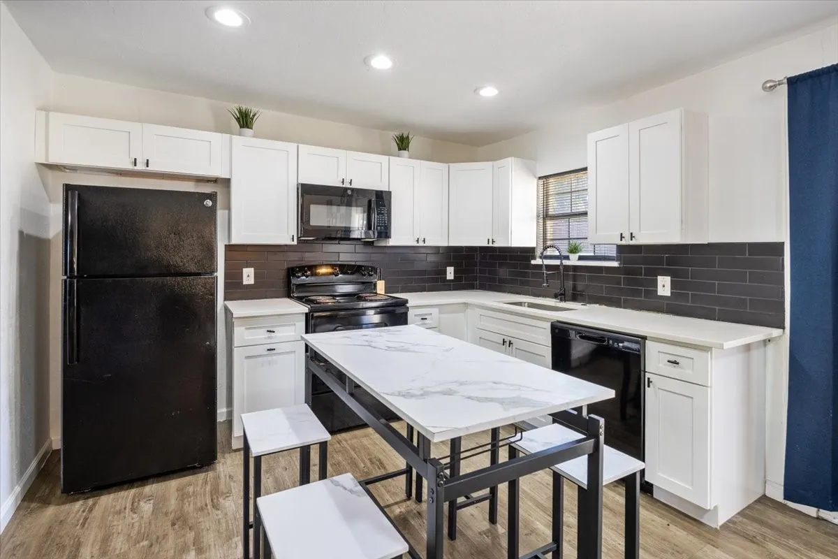 Kitchen with white cabinets and subway tile backsplash.