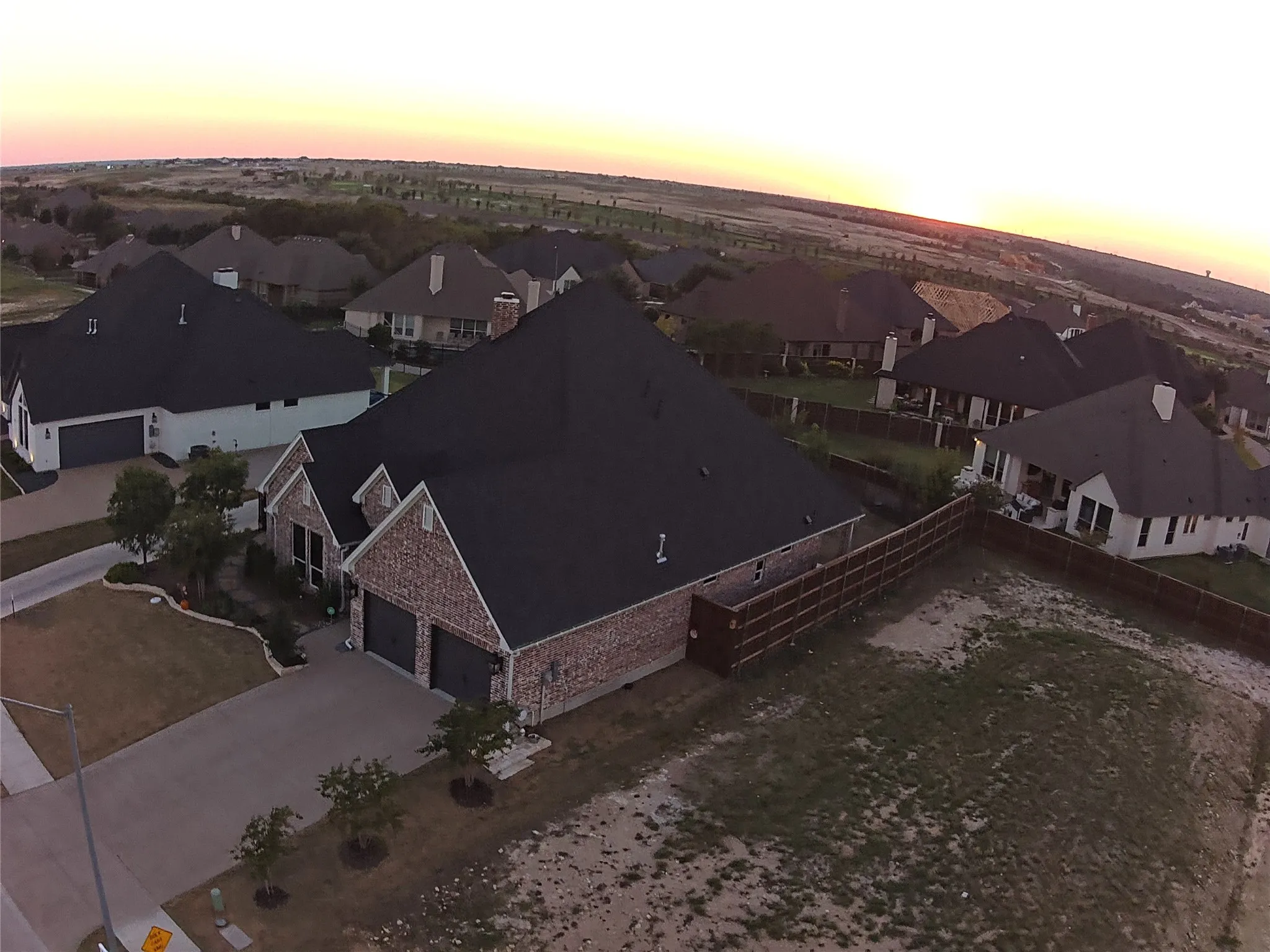 Brick and stone exterior with dark roofing
