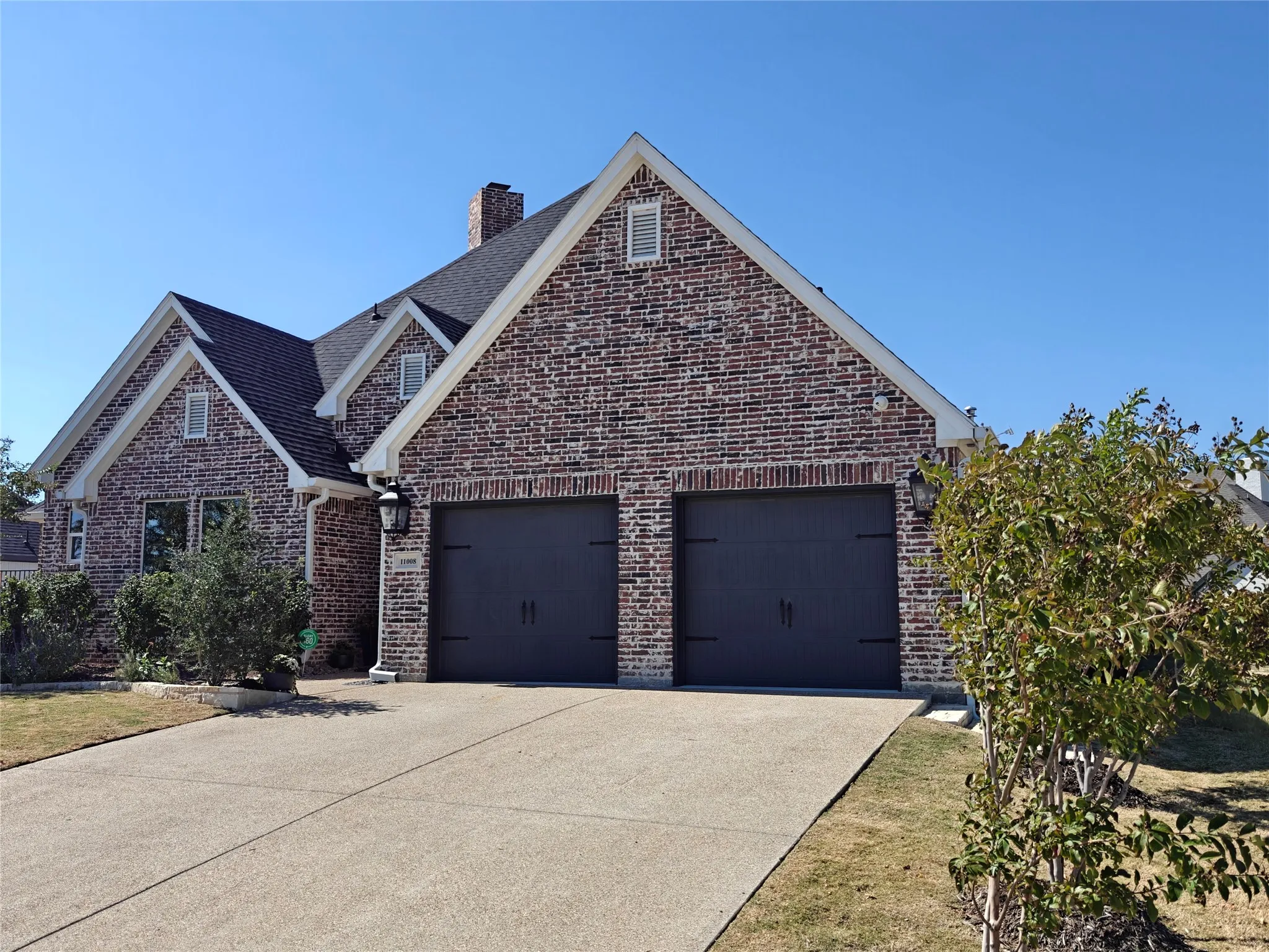 Striking brick exterior with architectural gable detailing and dormer windows