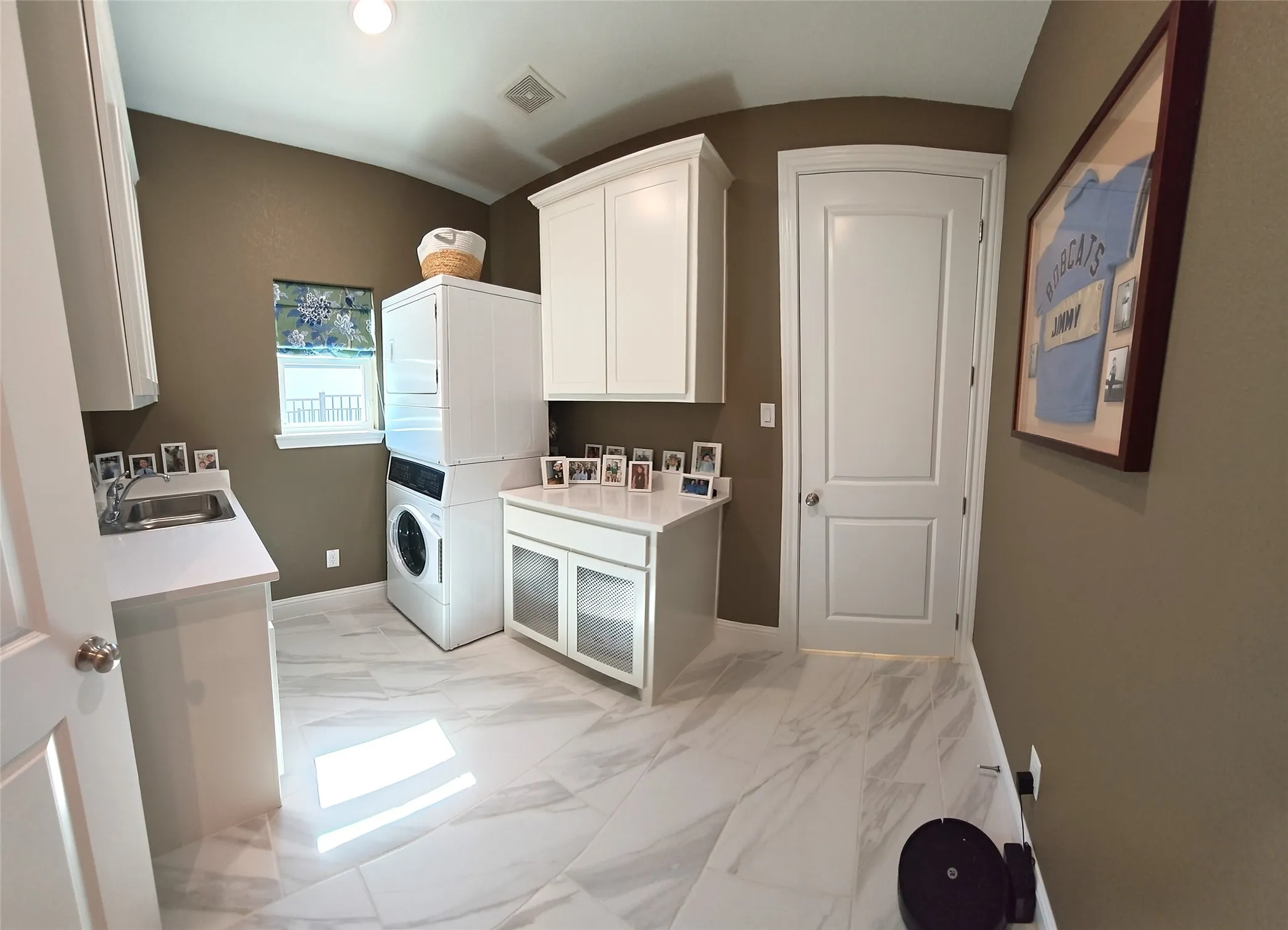 White cabinetry, integrated sink, tiled flooring, built-in countertop, and window