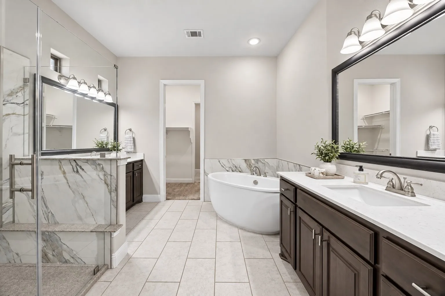Primary Bath with dual vanities and separate shower.