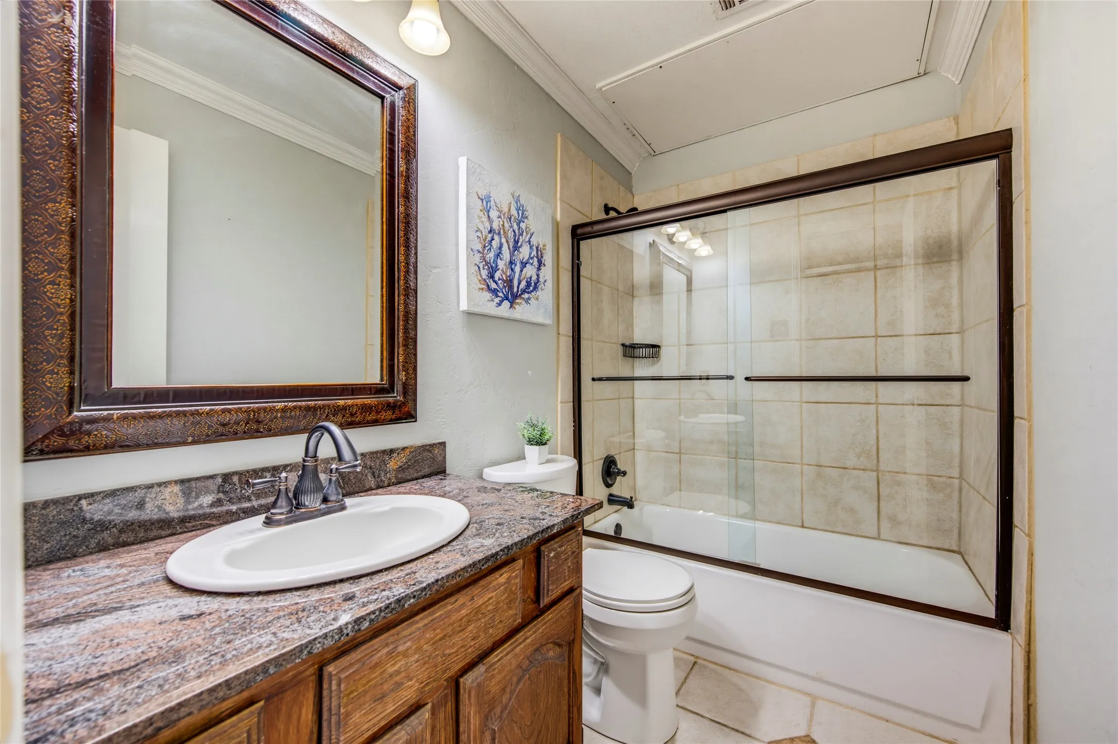 2nd bathroom with a tub with a sliding glass enclosure.....