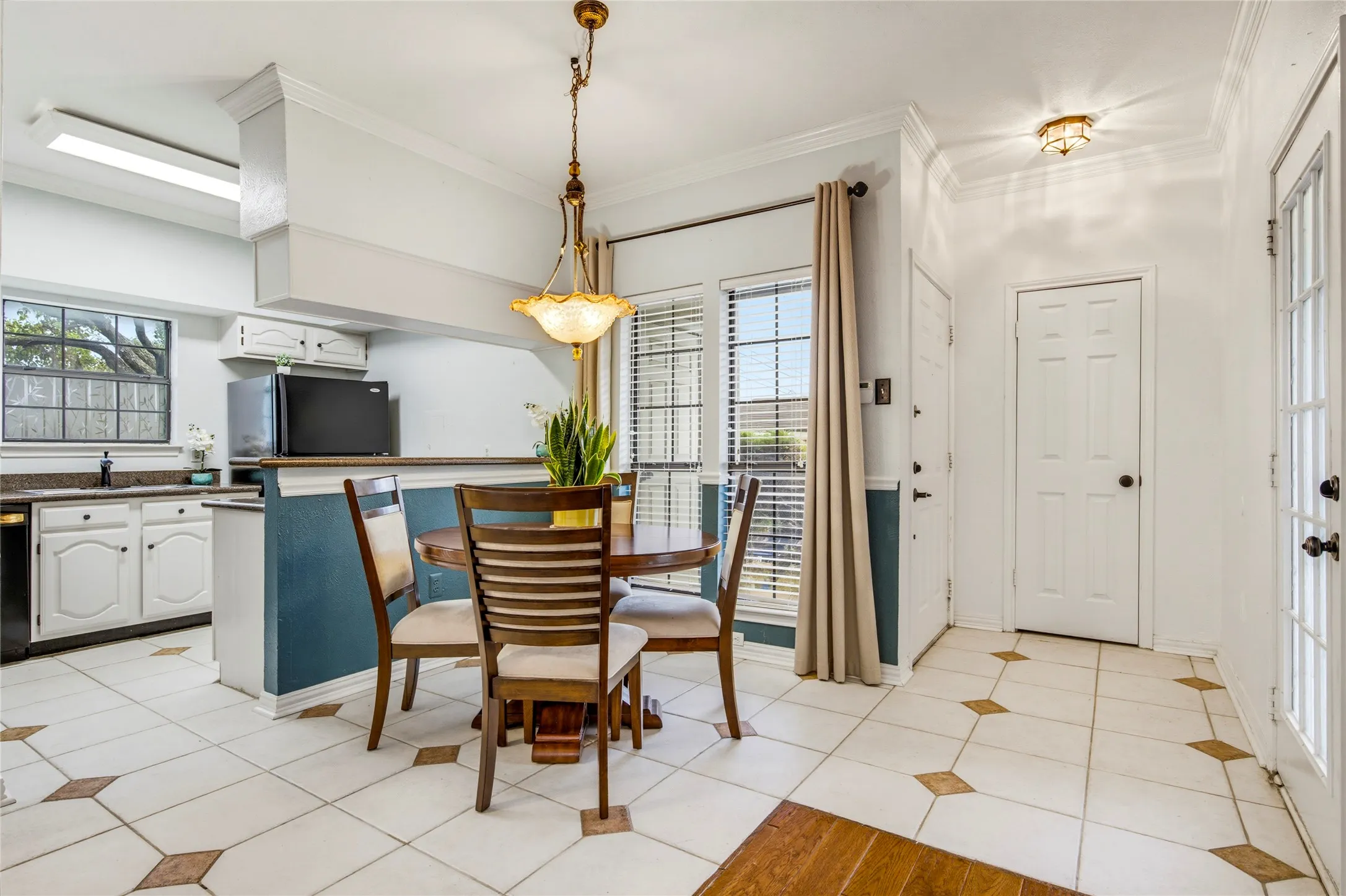 Gorgeous tiled flooring from the entry with accent inserts, recessed lighting, cozy dining space and a kitchen featuring white cabinetry and granite countertops....