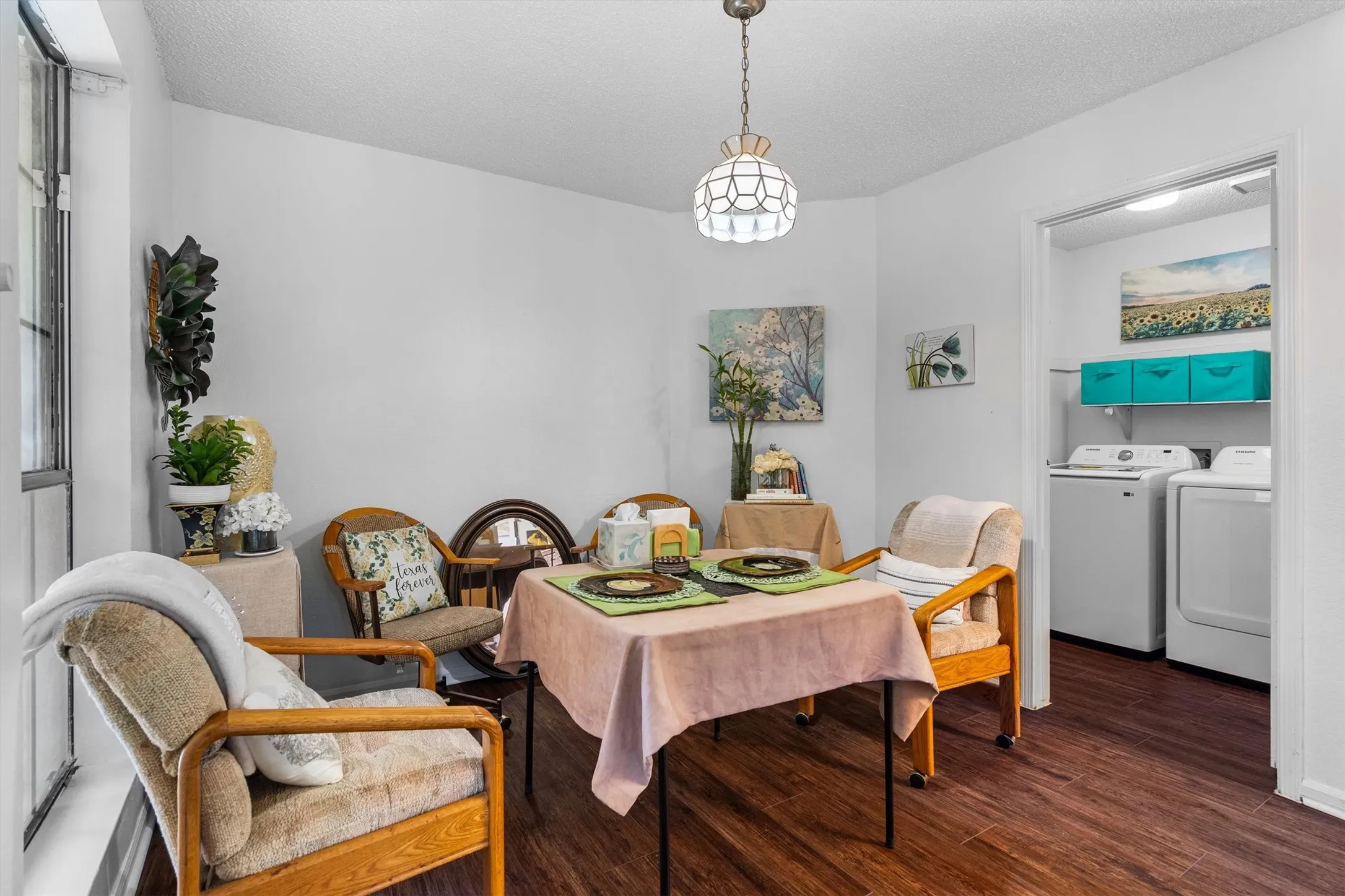 Wood-finish flooring, white walls, and a built-in laundry area with shelving