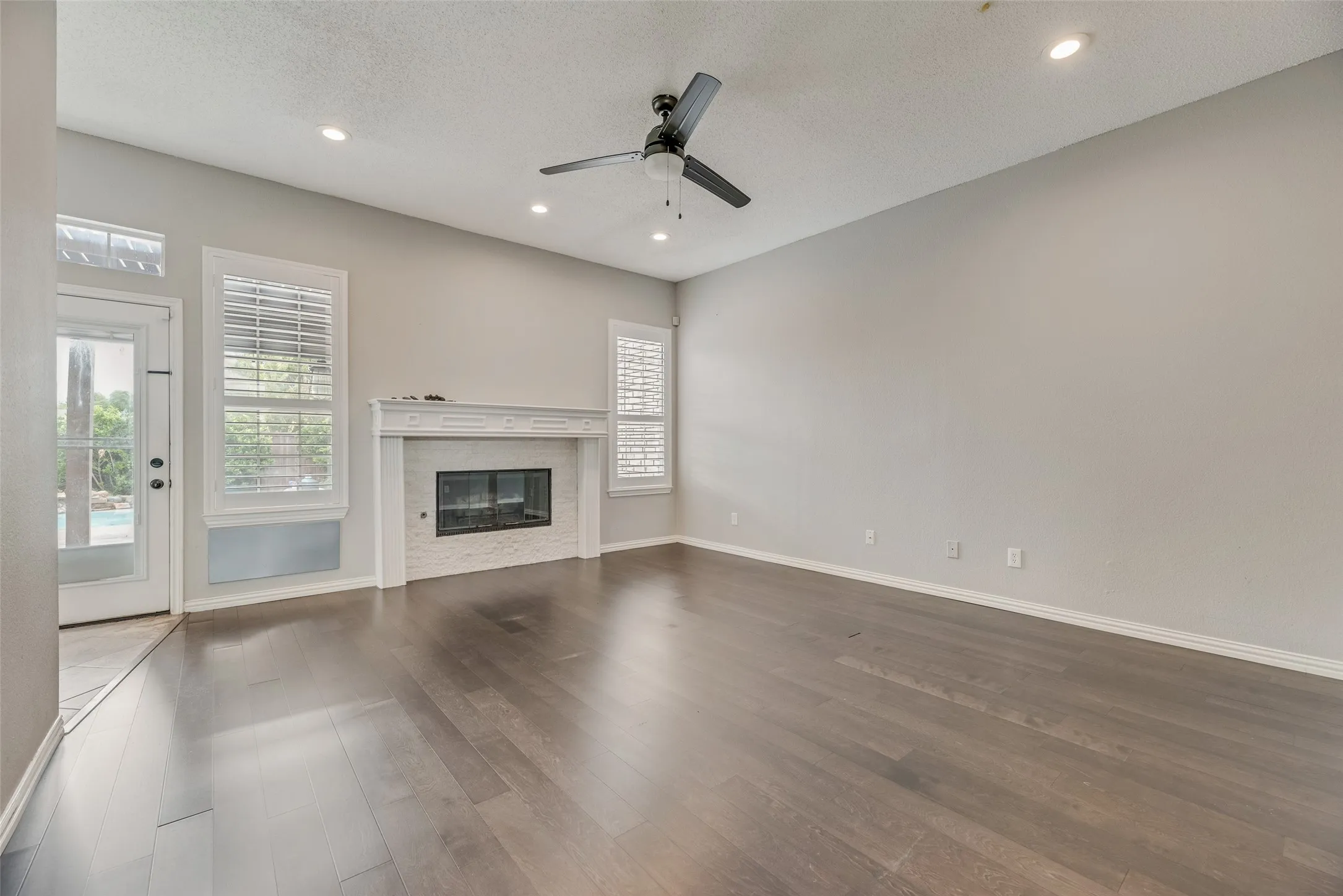 Wood-finish flooring, recessed lighting, and a ceiling fan